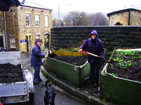 Two Incredible volunteers tend a garden plot in the town. Photo Courtesy: Incredible Edible